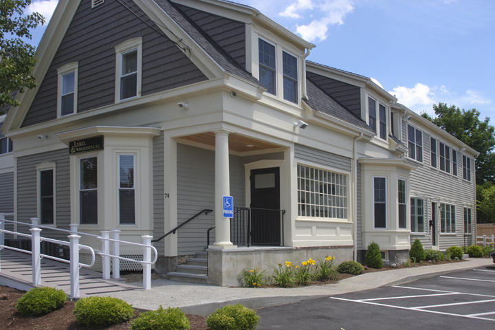 Clapboard commercial building with a columned entry porch